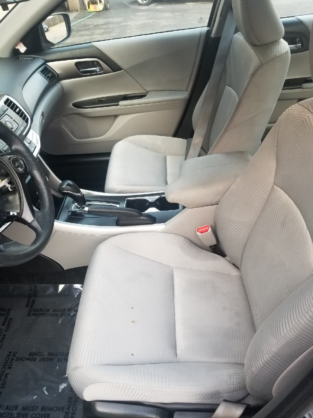 After detailing: cleaned cream cloth seats, armrest, and door panels