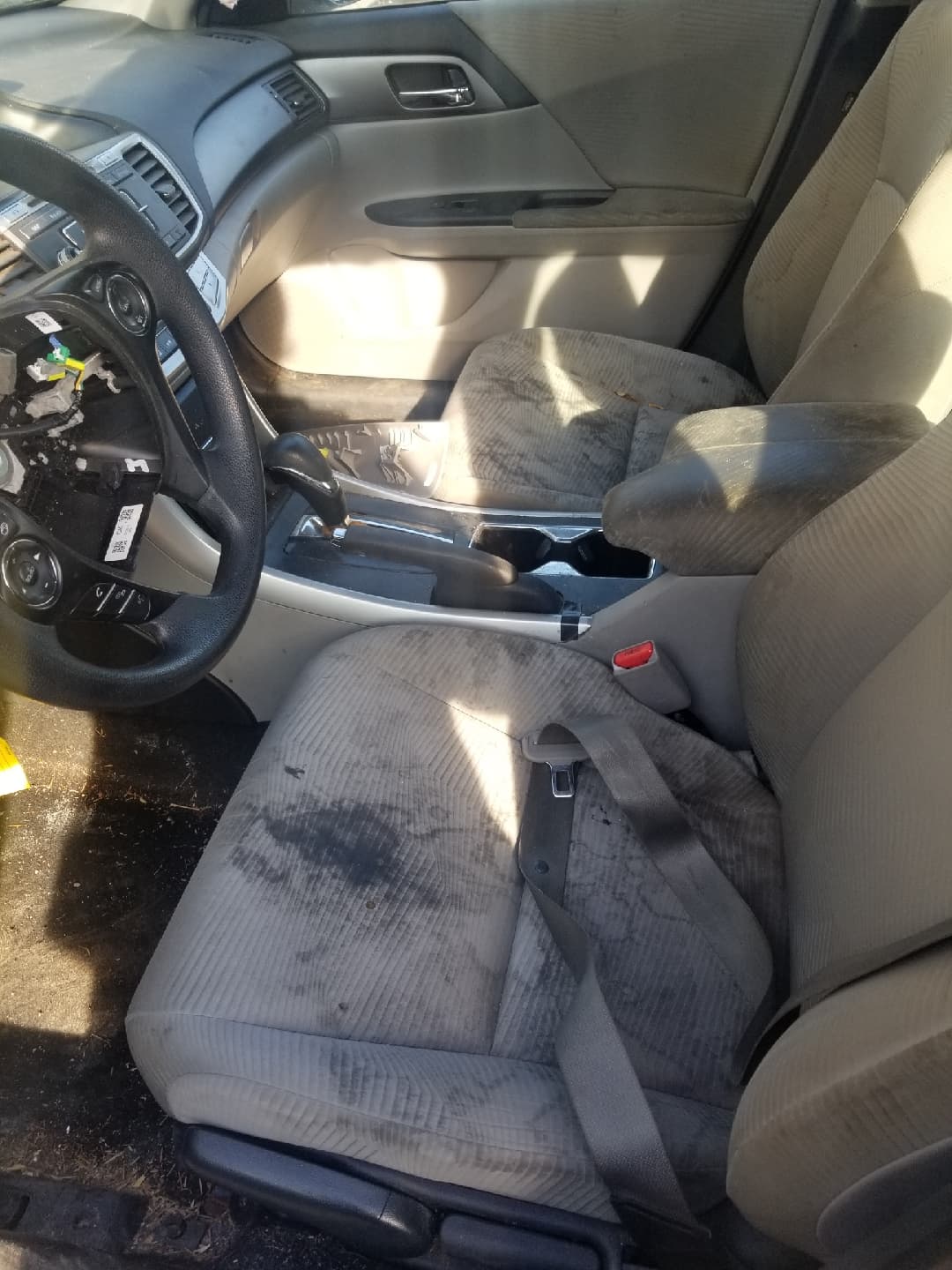 Before detailing: cream cloth seats and armrest with dark stains
